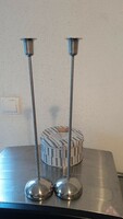 Silver colored metal candle holders together