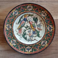 Antique ceramic wall decoration with parrots