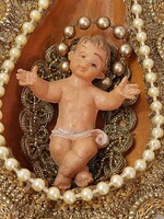 Handmade Christmas tree decoration with baby Jesus in the manger