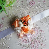 A new, custom-made orange-white wrist ornament with roses and pearls