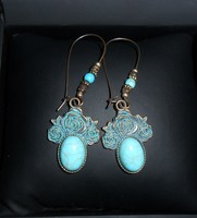 Boho-style, flower-patterned, turquoise-bronze earrings with stones.