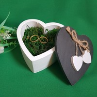 New, heart-shaped, heart-decorated wedding ring box with wooden moss