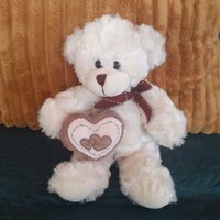 Russ is a white teddy bear with a teddy bear heart