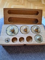 Old copper weights in a wooden box