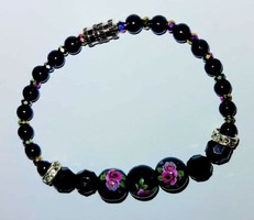 Women's black flower bracelet with black polished pearls.