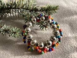 Christmas tree decoration with an old glass tapestry-style wreath with colored beads