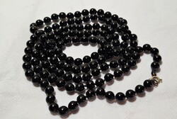 Long string of black glass beads