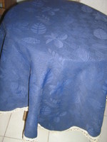 Elegant woven tablecloth with beautiful blue leaves and lacy edges