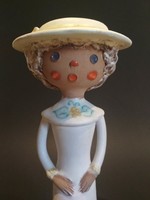 Ceramic figurine of a woman in a hat