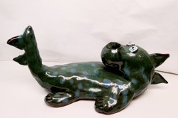 A monster of a dragon lying on its back. Ceramic candle holder Steffi Herz Germany