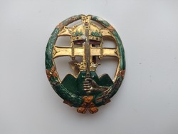 Badge with crown and sword