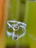 A silver ring with a clean shape, with an olivine stone