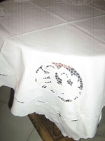 Beautiful white rosette tablecloth with a Christmas pattern in the four corners