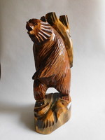 Large wooden carved bear carrying a log 31 cm