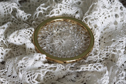 Gold-colored, metal-rimmed, crystal-like coaster