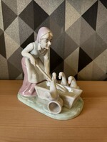 Porcelain figurine of an old woman feeding poultry