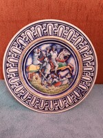 Painted-glazed ceramic wall plate, with a plastic battle scene, marked 'gerz germany'.