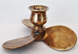 An old ship's candle holder in the shape of a copper propeller