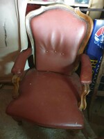 Antique baroque armchair with leather cover.