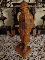 Vintage wooden carved statue of a piper