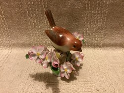 Herend marked porcelain bird among flowering tree branches