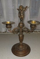 Antique angel statue, on top of the candle holder. Two arms.