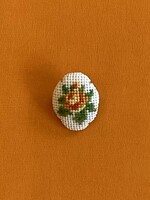 Rose brooch with inlay on pin, in several colors.