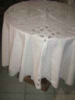A beautiful oval tablecloth with white rosette flowers
