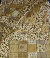 Vintage set with a patchwork pattern: bed cover, decorative pillow covers, table cover, chair cushions