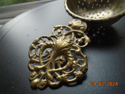 Decorative copper openwork casting with tongs, filter