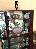 An old showcase with many beautiful objects in it