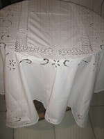 A beautiful white tablecloth with a hand-crocheted edge and inlay