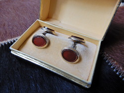 Old gold-plated cufflinks with a pair of red glass stones