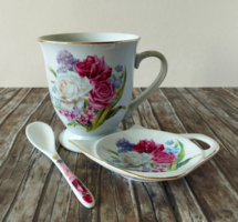 A porcelain tea set with a beautiful bouquet of roses