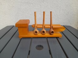 Pipe holder with carved wooden pipes