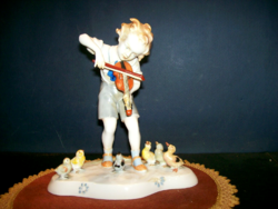 Boy figure playing the violin to his friends