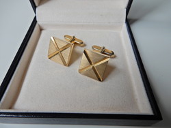 Old gilded cufflinks with a pair of engraved decorations