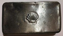 Embossed metal logo printed in the vintage material of a Shell metal box