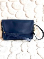 Elegant retro women's bag with golden hardware on the sides and bottom of dark blue leather