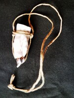 A porcelain brandy glass that can be hung around the neck in the shape of a pig's foot