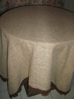 Beautiful taupe hand-crocheted brown woven tablecloth with lace edges and rounded corners
