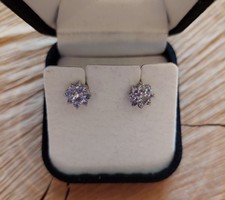 Flower-shaped silver earrings with purple zirconia stones