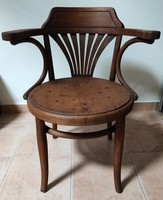 Old barber chair with armrests