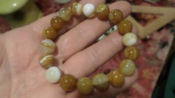 A rubber bracelet made of approx. 1 cm mineral pearls.
