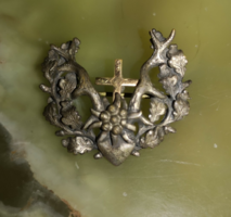 Silver brooch with gold cross