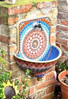 Wall well, fountain, hand basin decorated with mosaics
