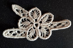 An appliqué garment ornament made with cord crochet