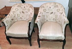 A pair of armchairs with art deco characters