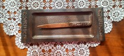 A copper/bronze leaf-cutting knife marked by an artisan on a tray
