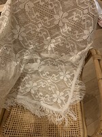 A very beautiful lace tablecloth with a fringe border